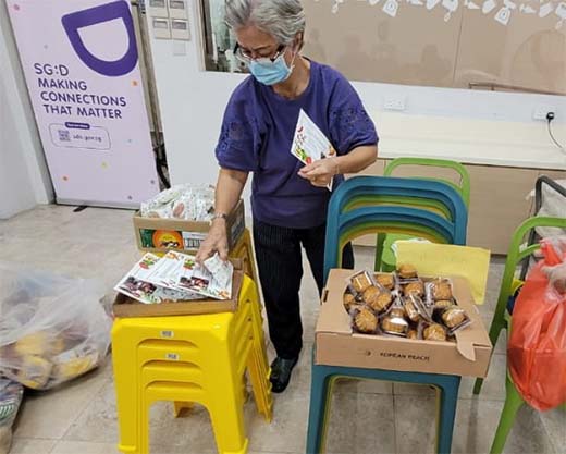 Auntie Sally helping to sort mooncakes for distribution