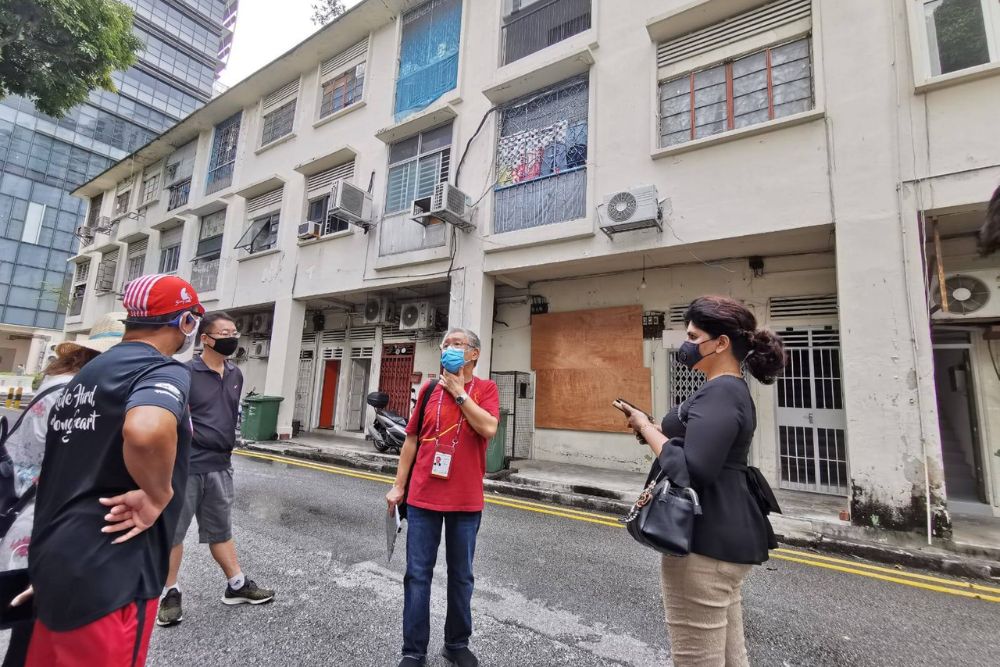 Meet Uncle Chris, The 70-Year-Old Guide Leading “X-Rated” Walking Tours That Dive Into The History Of Singapore’s Seediest Districts - Uncle Chris leads tour at Flanders Square