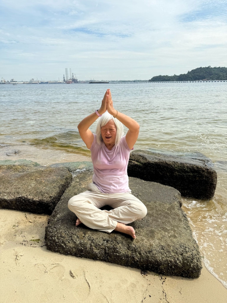 Coney Island: A Nature Respite For An Easy Hike In Punggol - Practising yoga by the beach