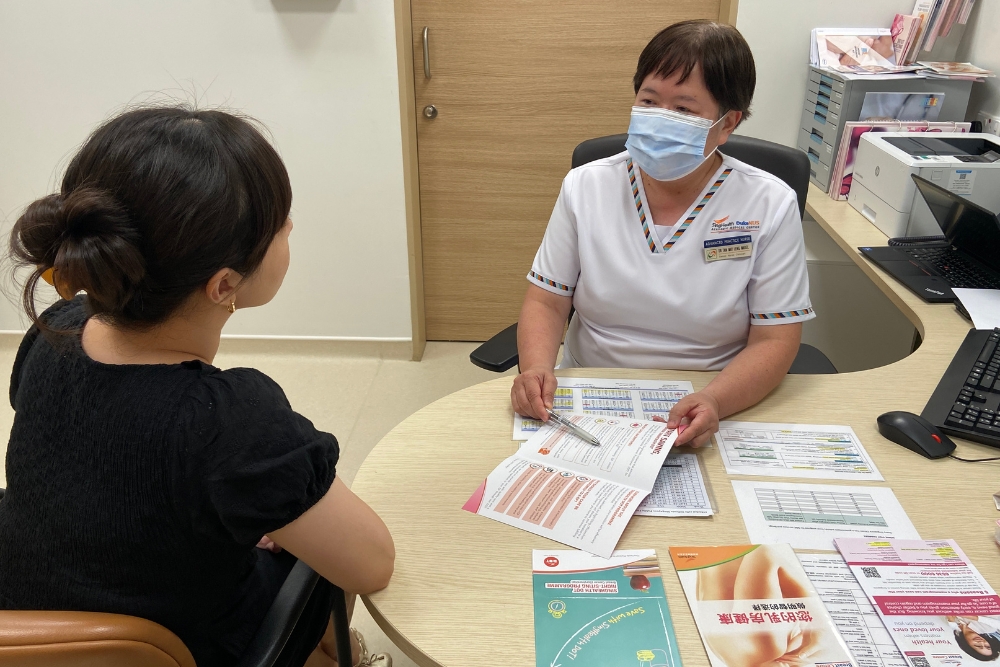 Nurses' Day: Celebrating Senior Nurses Who Have Made A Mark In Their Field - Mabel consulting patients at NCCS